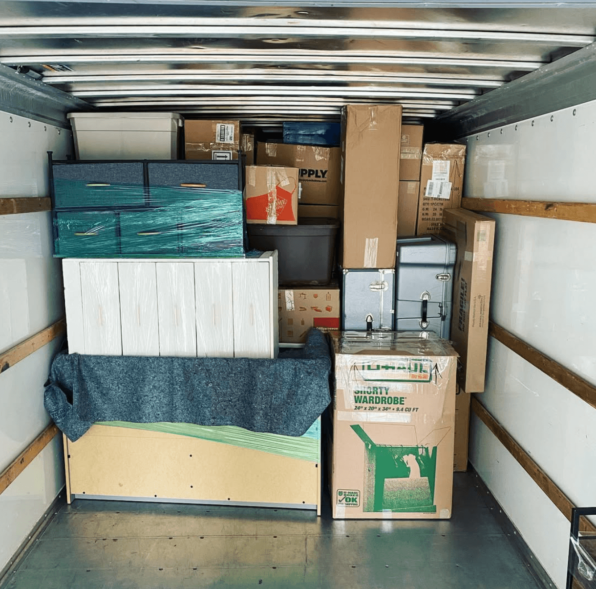 Moving truck packed with labeled boxes and wrapped furniture for a local move.
